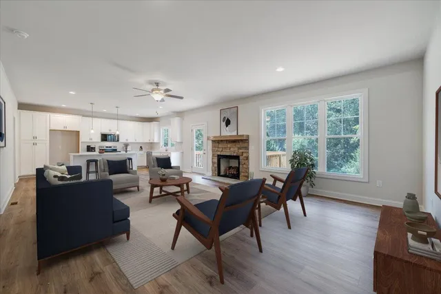a living room with furniture fireplace and flat screen tv