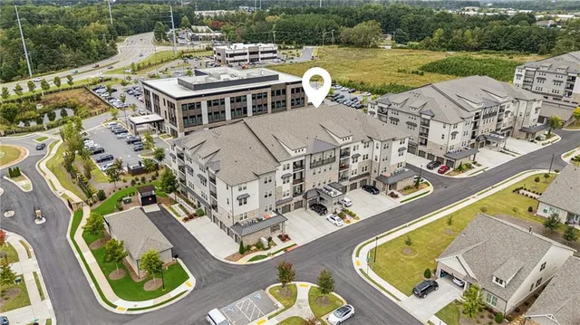 an aerial view of a house with a swimming pool and outdoor seating