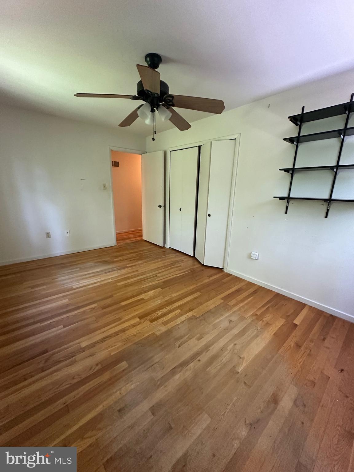 11152 Forest Edge Drive Reston, VA 20190 - Photo 51 of 102 a view of a room with a ceiling fan and hardwood floor