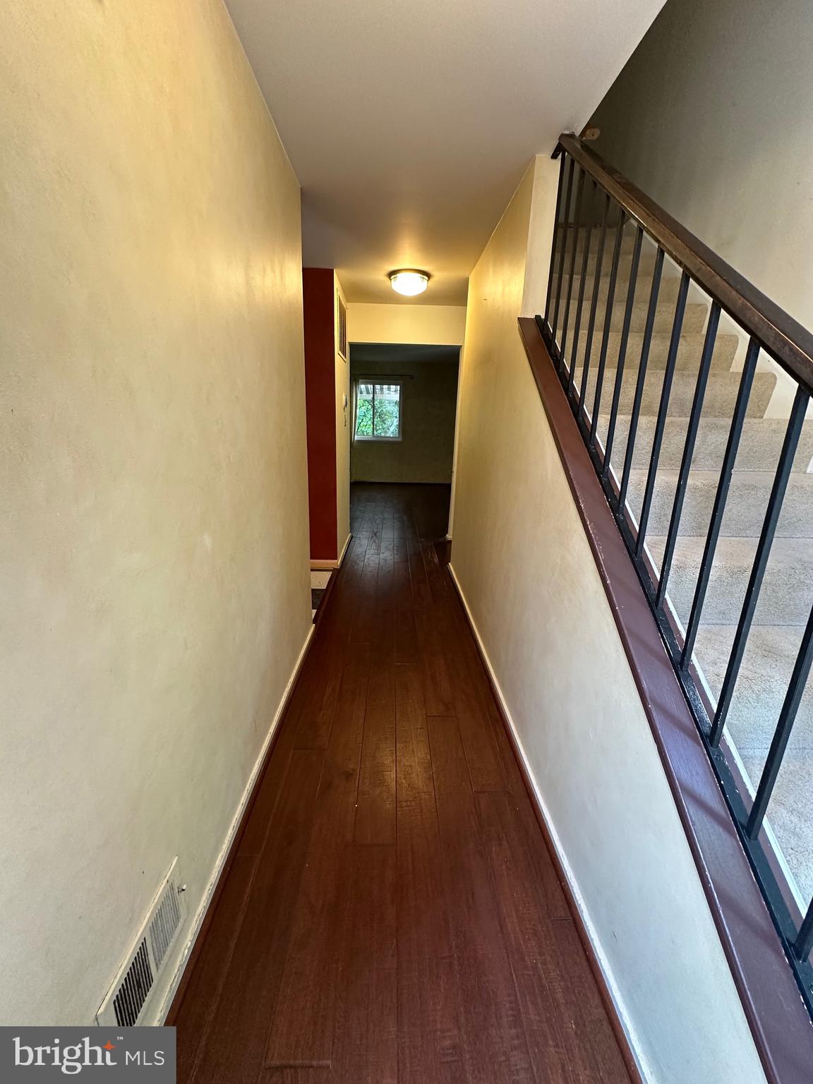 11152 Forest Edge Drive Reston, VA 20190 - Photo 79 of 102 a view of a hallway with wooden floor and stairs