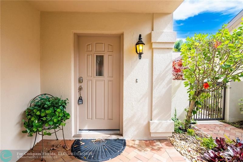 121 Landward Drive Jupiter, FL 33477 - Photo 11 of 43 a potted plant sitting in front of a house with a potted plant