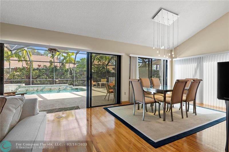 121 Landward Drive Jupiter, FL 33477 - Photo 17 of 43 a dining room with furniture a chandelier and wooden floor