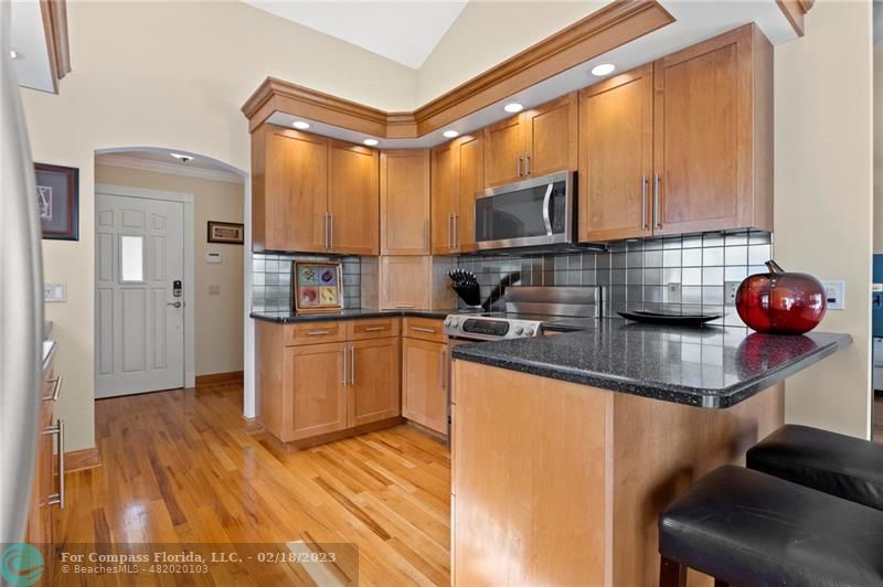 121 Landward Drive Jupiter, FL 33477 - Photo 19 of 43 a kitchen with stainless steel appliances granite countertop a sink refrigerator and microwave