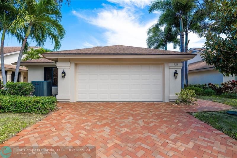 121 Landward Drive Jupiter, FL 33477 - Photo 2 of 43 a front view of house with yard and trees