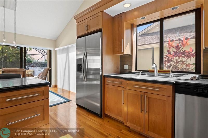 121 Landward Drive Jupiter, FL 33477 - Photo 22 of 43 a kitchen with stainless steel appliances granite countertop a refrigerator and a sink