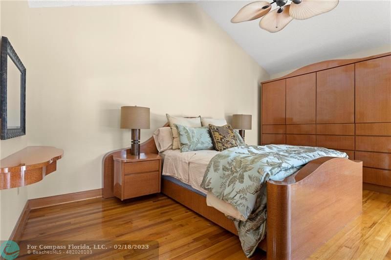 121 Landward Drive Jupiter, FL 33477 - Photo 24 of 43 a bedroom with a bed and a chandelier