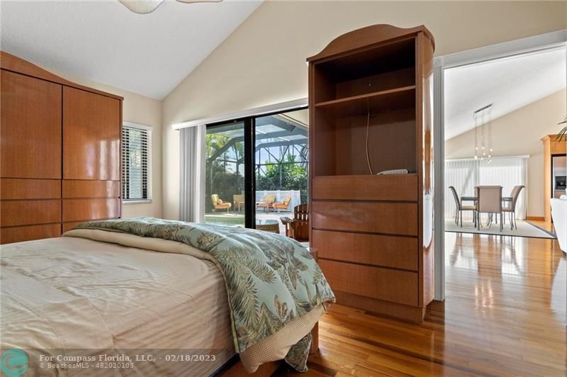 121 Landward Drive Jupiter, FL 33477 - Photo 25 of 43 a bed sitting in a bedroom next to a window