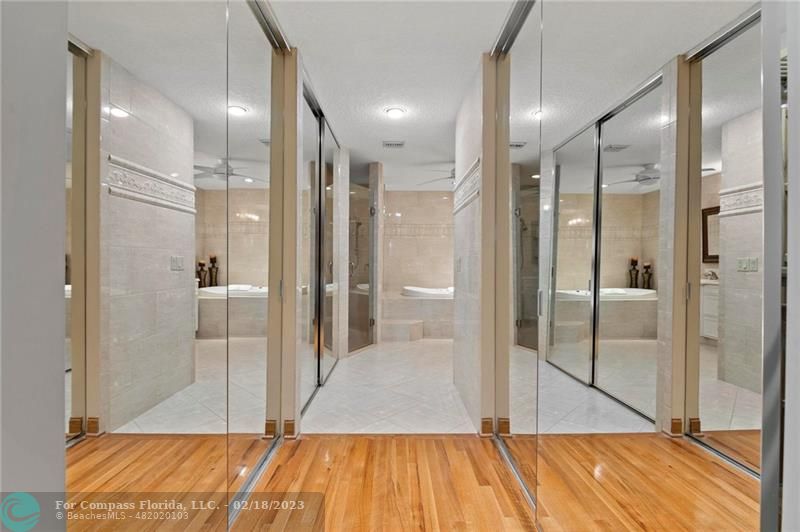 121 Landward Drive Jupiter, FL 33477 - Photo 26 of 43 a bathroom with a glass shower door and a glass door