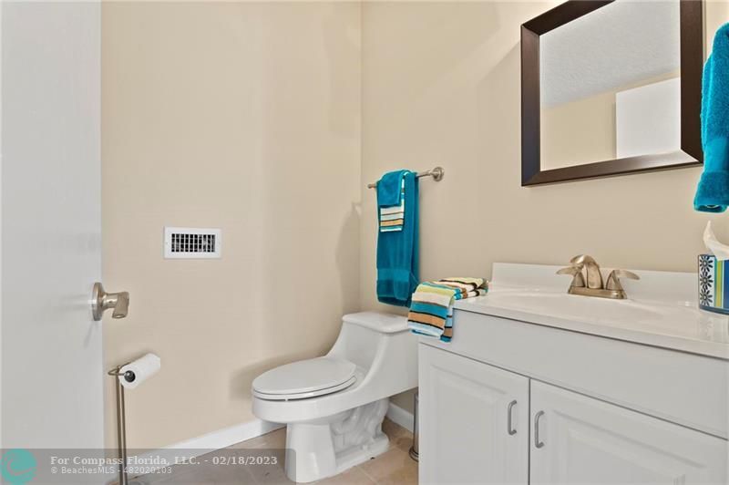 121 Landward Drive Jupiter, FL 33477 - Photo 37 of 43 a bathroom with a toilet sink and mirror