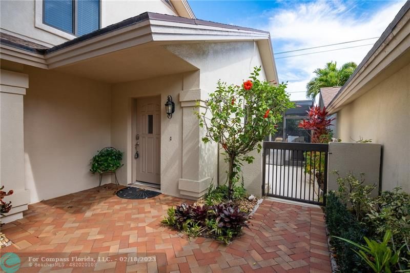121 Landward Drive Jupiter, FL 33477 - Photo 4 of 43 a potted plant sitting in front of a house