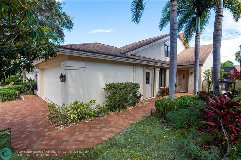 121 Landward Drive Jupiter, FL 33477 - Photo 43 of 43 a front view of a house with garden