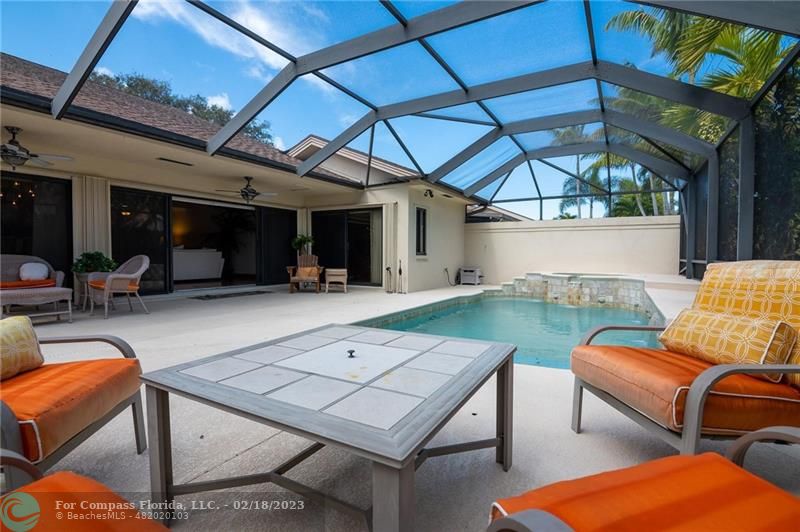 121 Landward Drive Jupiter, FL 33477 - Photo 7 of 43 a view of a patio with couches table and chairs with wooden floor