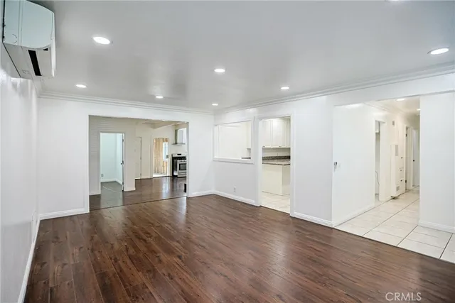 a view of an empty room and wooden floor