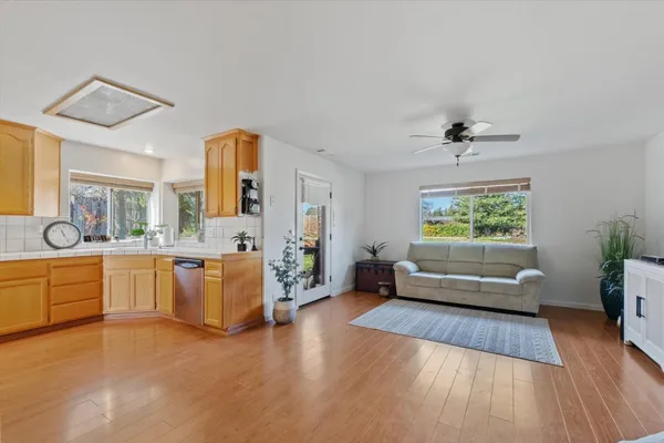 a living room with furniture and wooden floor
