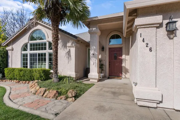 a front view of a house with a garden