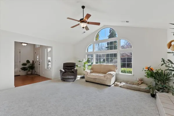 a living room with furniture chandelier and a fireplace