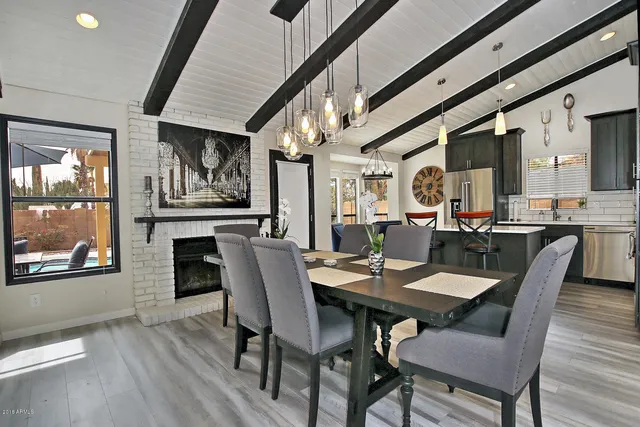a view of a dining room with furniture a chandelier and wooden floor