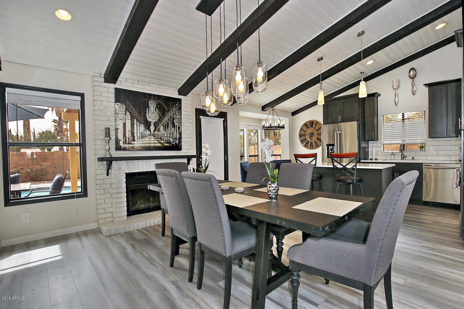 a view of a dining room with furniture a chandelier and wooden floor