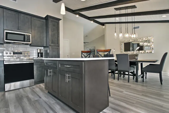 a kitchen with a sink cabinets and wooden floor