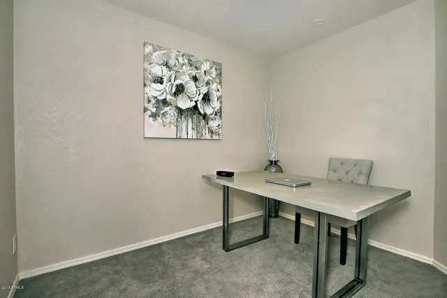 a view of a workspace with furniture