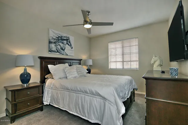 a bedroom with a bed and window