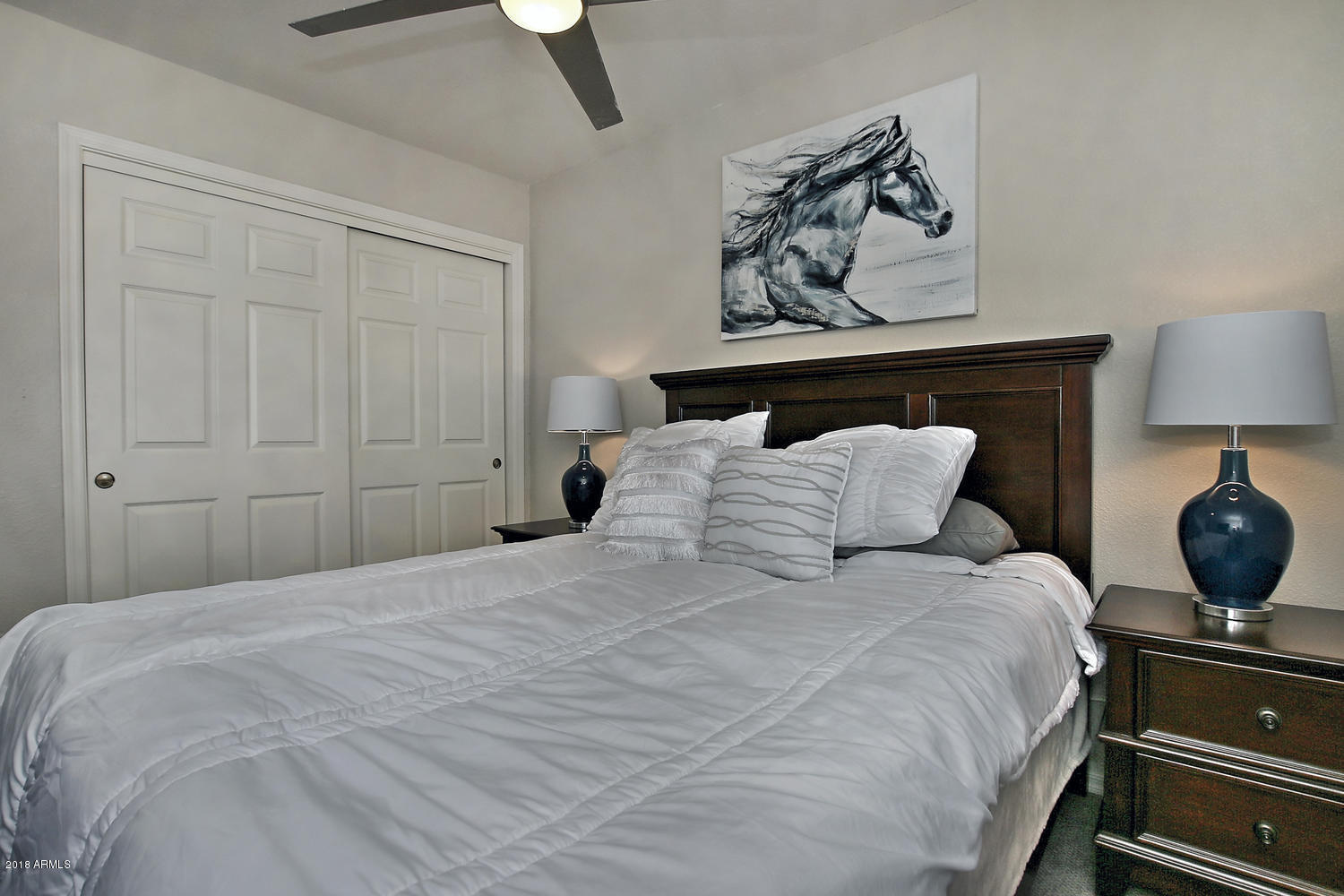 6521 East Grandview Drive Scottsdale, AZ 85254 - Photo 23 of 27 a bedroom with a bed and lamp on dresser