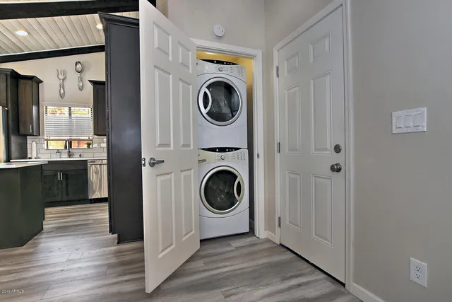 a view of a hallway with washer and dryer
