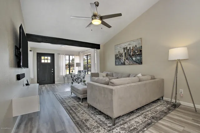 a living room with furniture and a chandelier