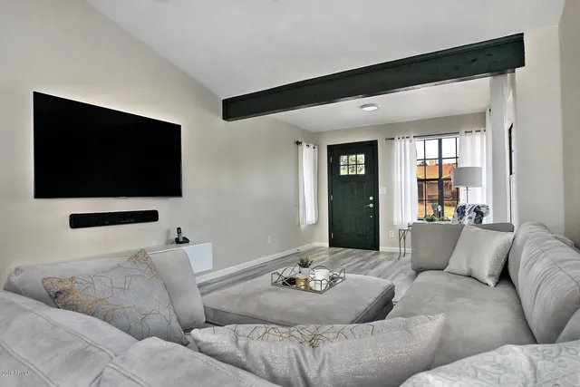 a living room with furniture and a flat screen tv