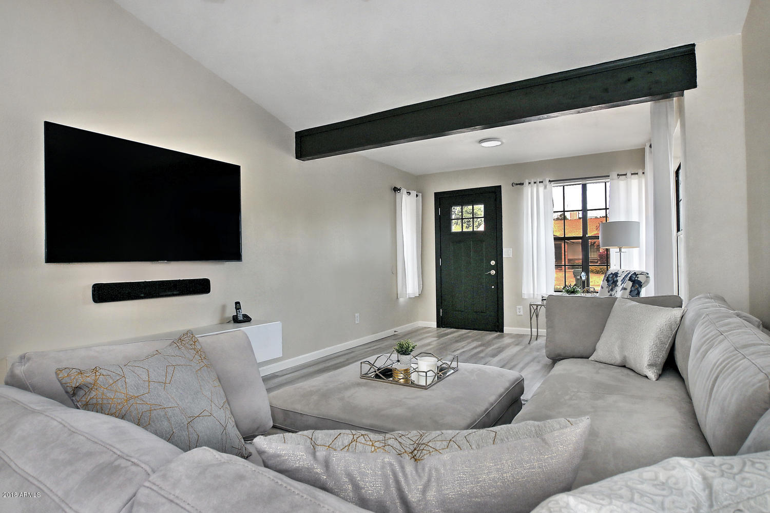 6521 East Grandview Drive Scottsdale, AZ 85254 - Photo 7 of 27 a living room with furniture and a flat screen tv