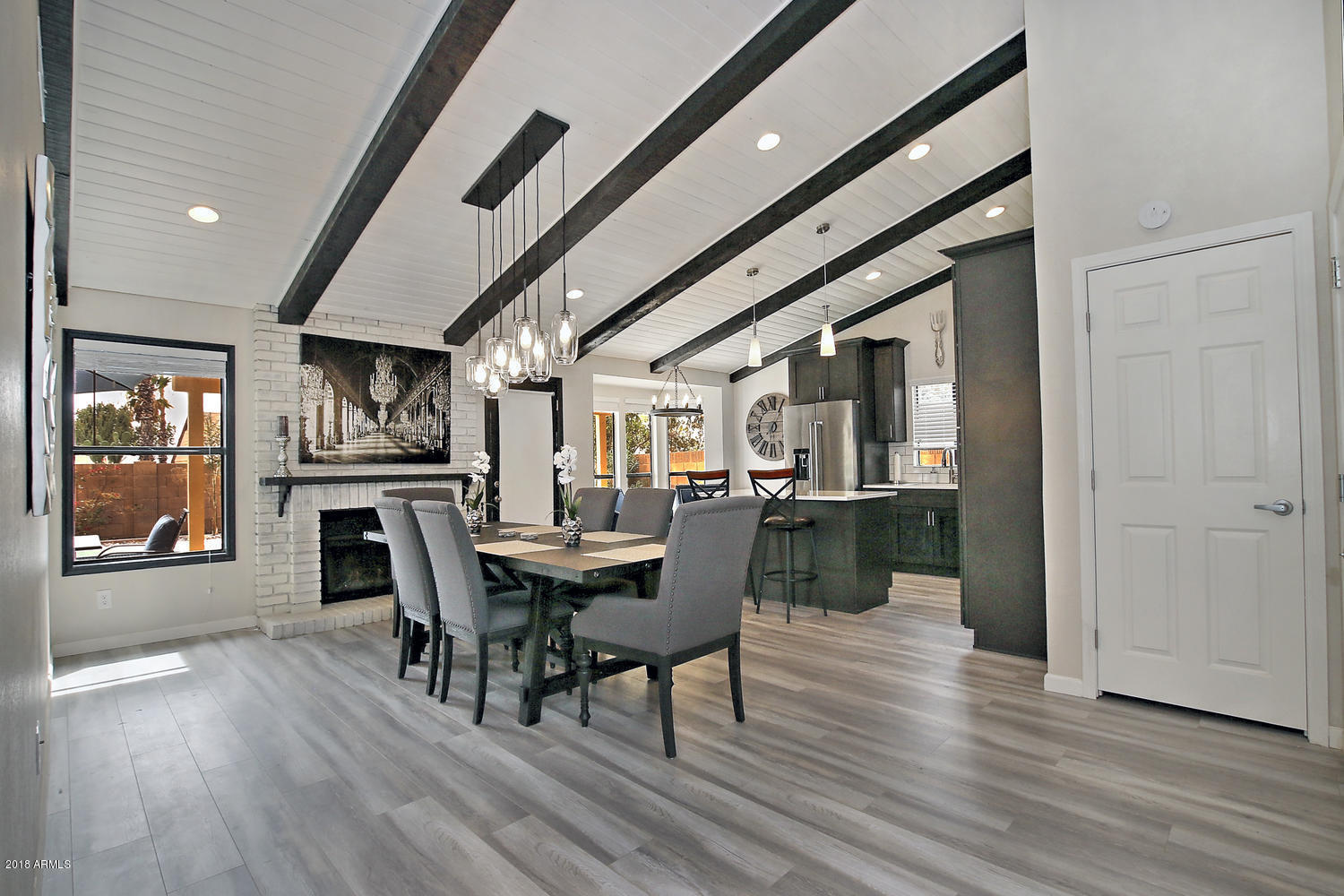 6521 East Grandview Drive Scottsdale, AZ 85254 - Photo 8 of 27 a dining room with furniture and wooden floor