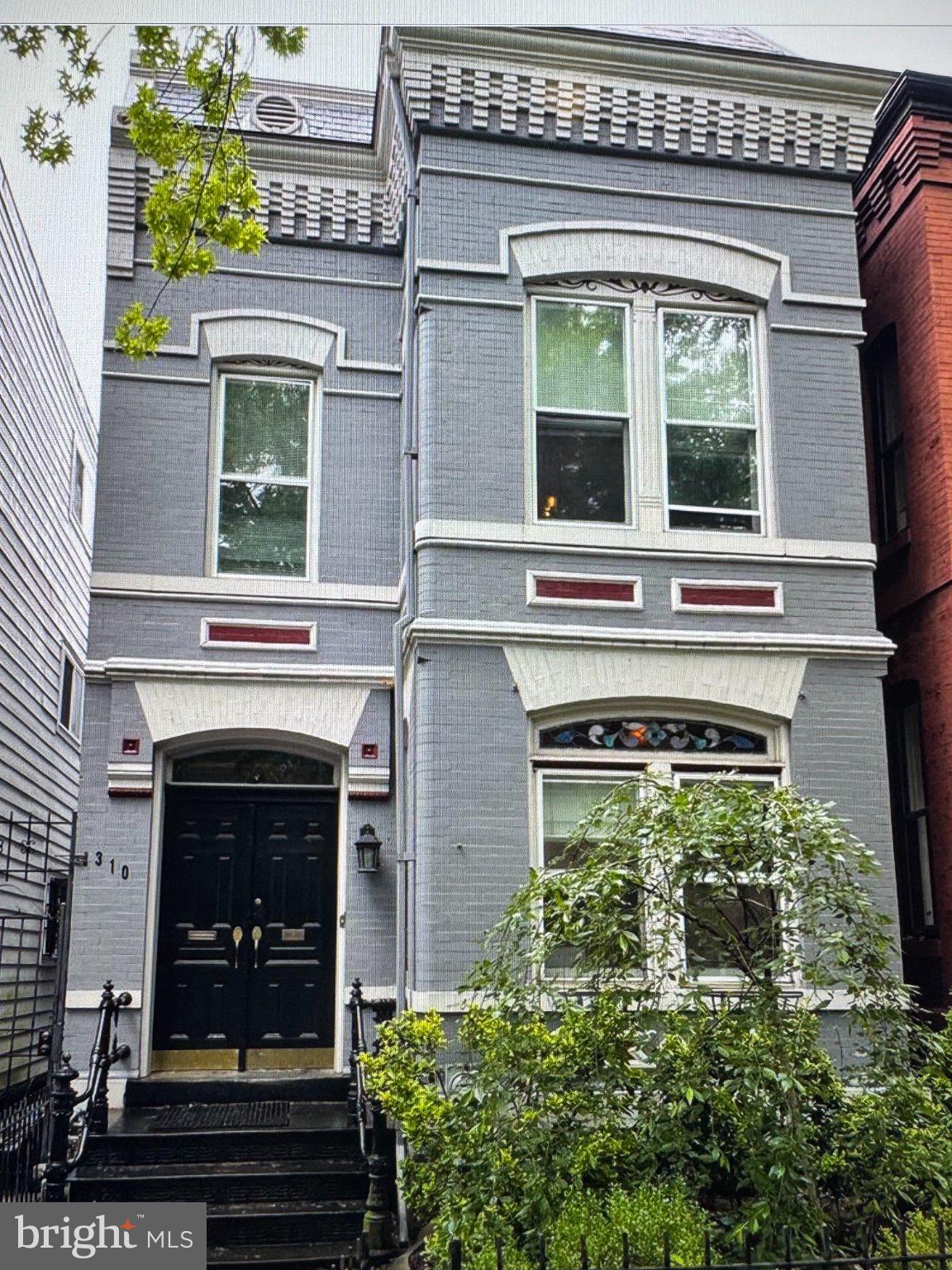 310 3rd Street Southeast Washington, DC 20003 - Photo 1 of 11 Charming gray facade with lush greenery.
