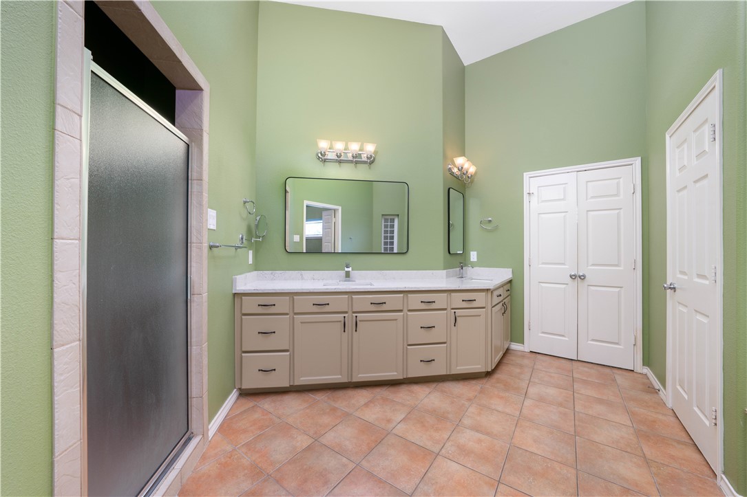 1034 Graham Road Corpus Christi, TX 78418 - Photo 11 of 40 a spacious bathroom with a granite countertop sink and a mirror