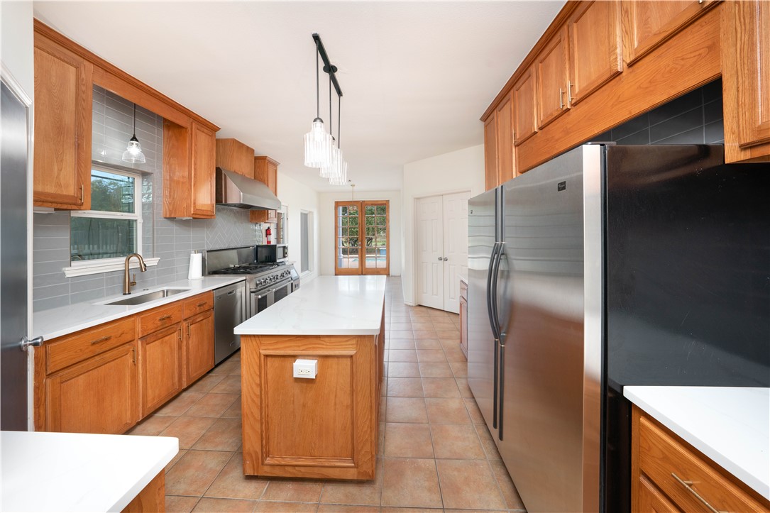 1034 Graham Road Corpus Christi, TX 78418 - Photo 17 of 40 a view of a kitchen with stainless steel appliances granite countertop a refrigerator and a sink
