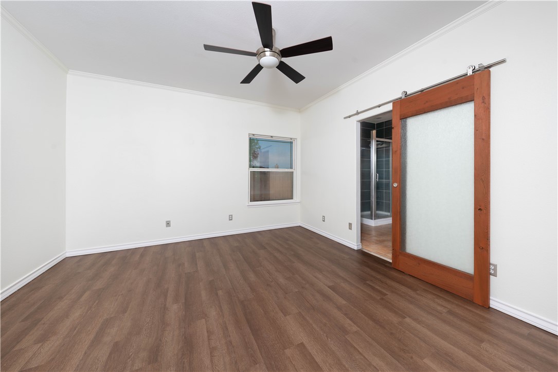 1034 Graham Road Corpus Christi, TX 78418 - Photo 29 of 40 a view of a room with wooden floor and a ceiling fan