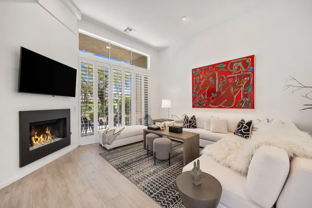 a living room with furniture fireplace and flat screen tv