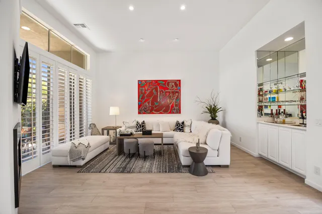 a living room with furniture or couch and a large window