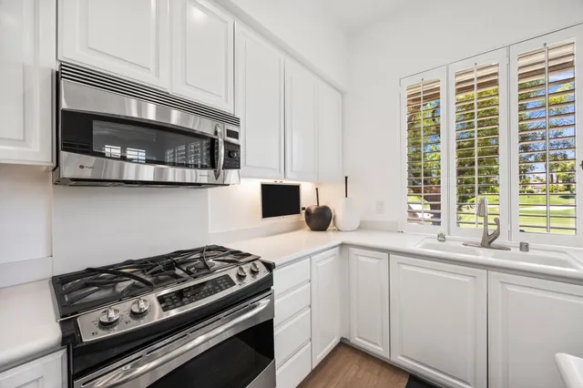 a kitchen with stainless steel appliances a stove and a microwave