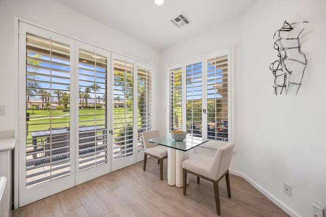 a view of a livingroom with furniture wooden floor and windows