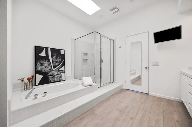 a spacious bathroom with a bathtub and a shower