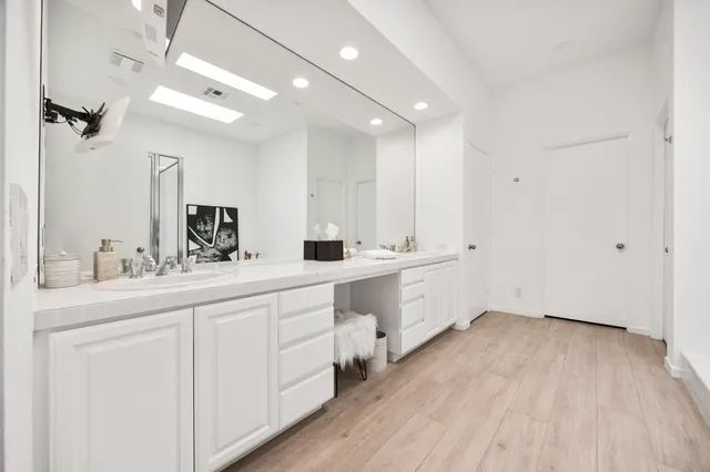 a spacious bathroom with a double vanity sink and a mirror