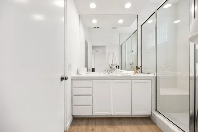 a bathroom with a double vanity sink and a mirror