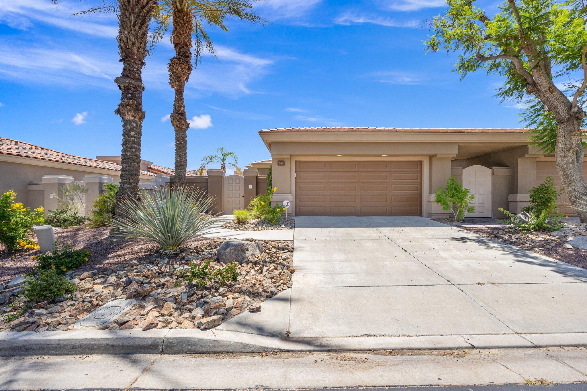 763 Box Canyon Trail Palm Desert, CA 92211 - Photo 32 of 48 a front view of a house with garden