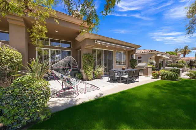 a view of a house with backyard porch and sitting area