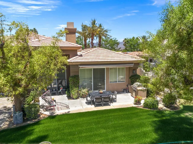a front view of a house with a garden and patio