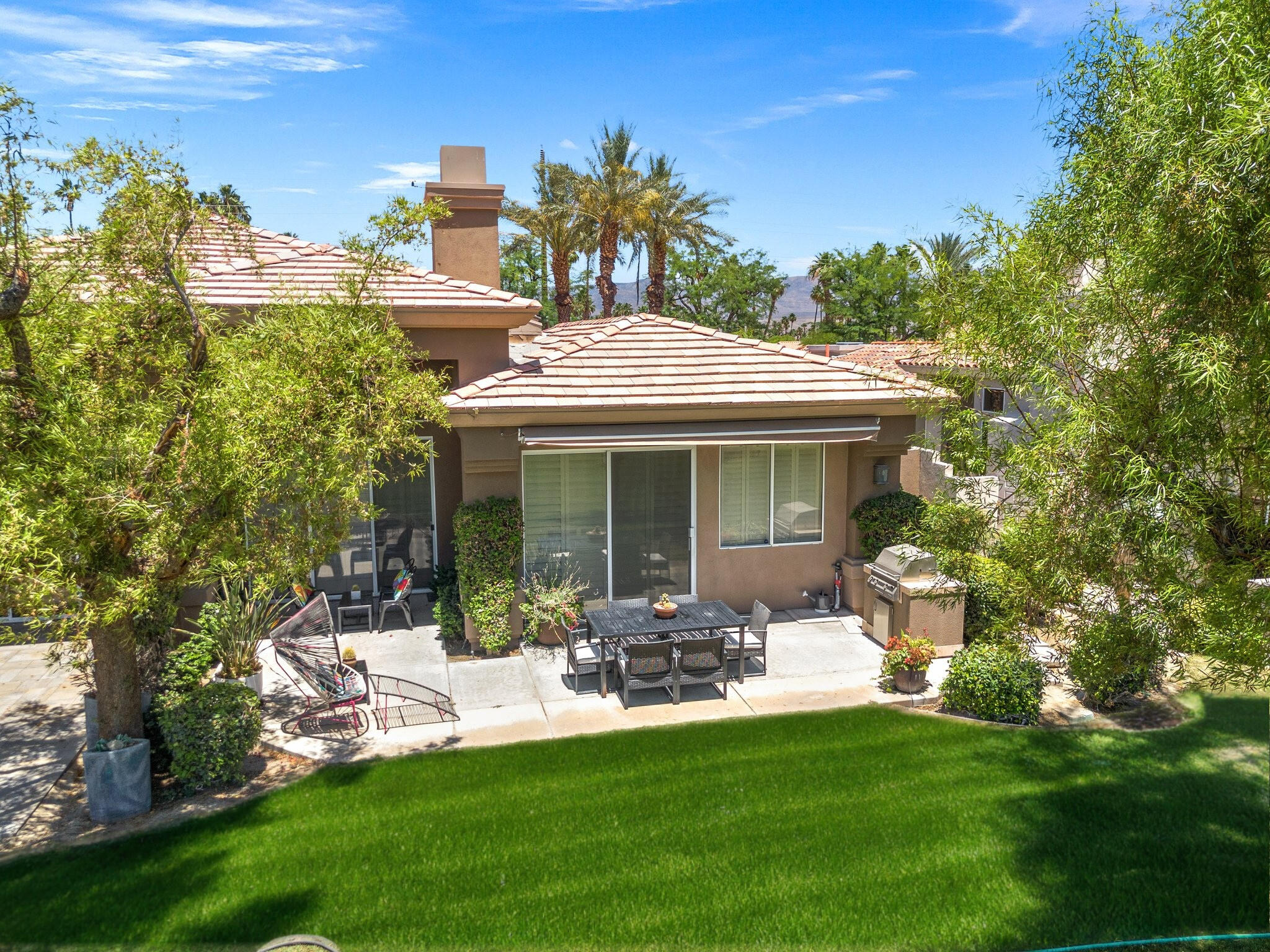 763 Box Canyon Trail Palm Desert, CA 92211 - Photo 36 of 48 a front view of a house with a garden and patio