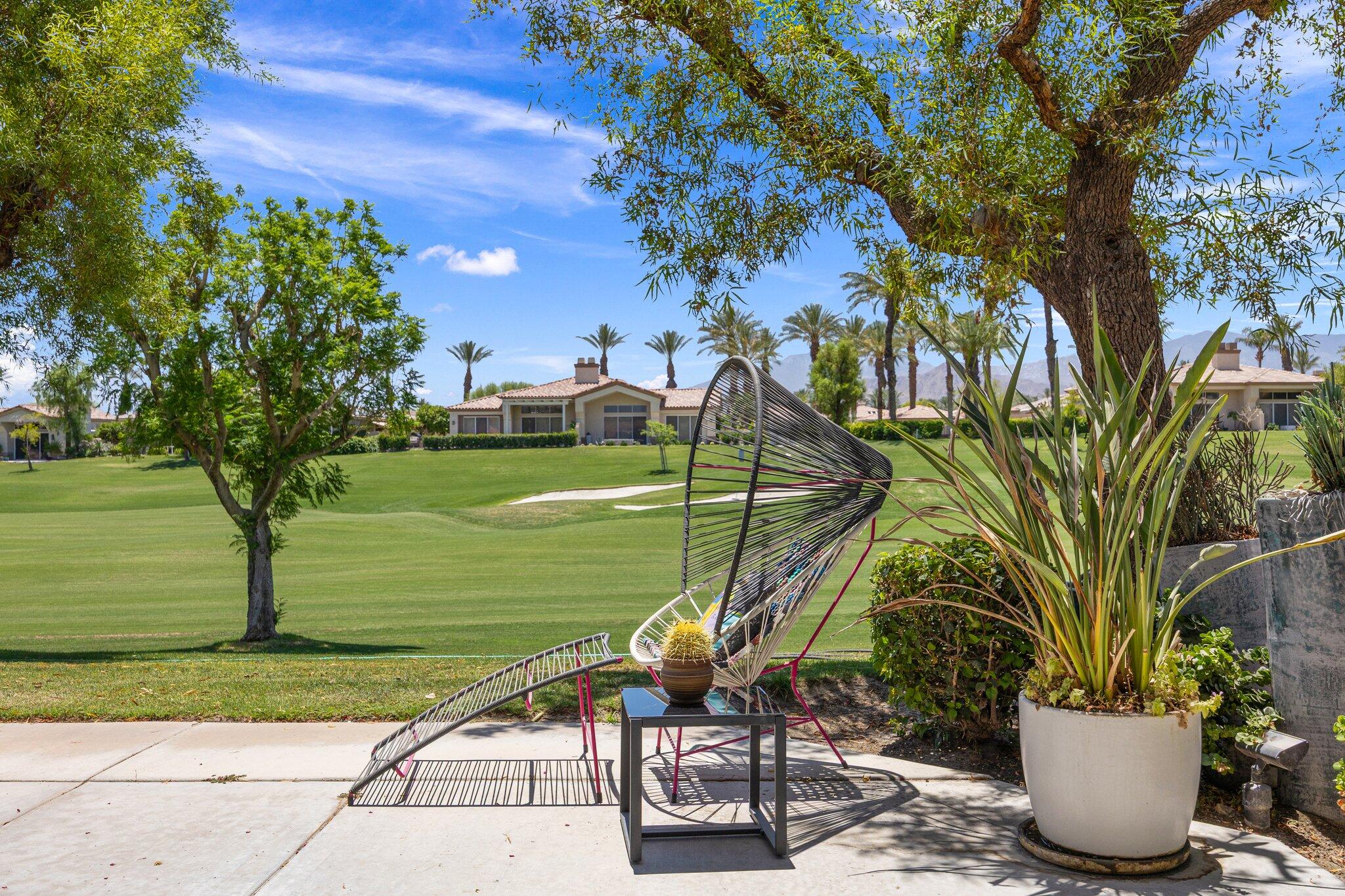 763 Box Canyon Trail Palm Desert, CA 92211 - Photo 42 of 48 a view of a backyard with plants and lake view