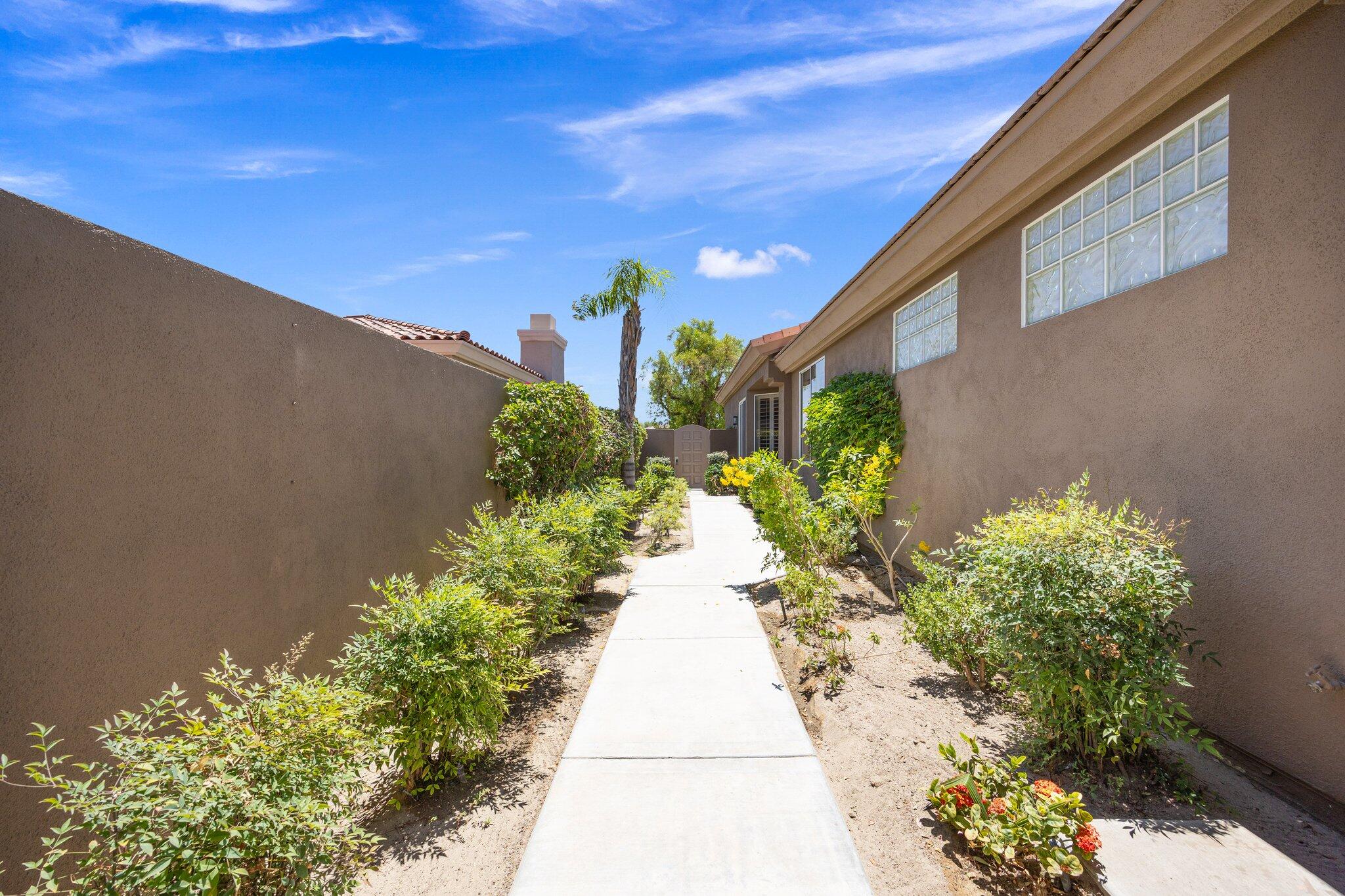 763 Box Canyon Trail Palm Desert, CA 92211 - Photo 6 of 48 a view of a pathway with flower plants
