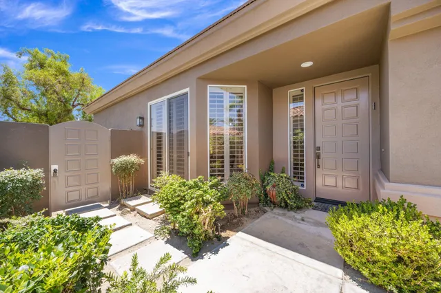 a view of a house with potted plants