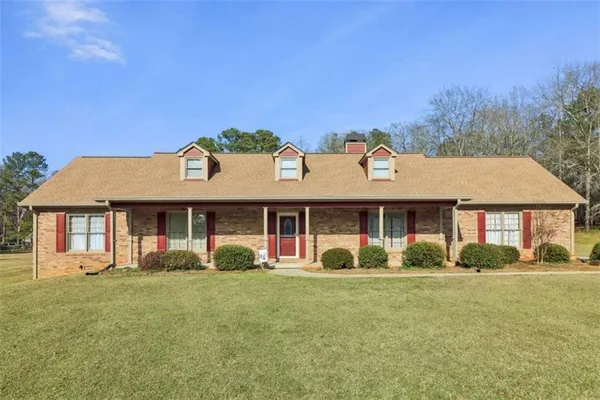 a front view of a house with garden